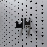 Horizontal pistol hanger mounted on GallowTech wall panel shown empty from a right-angle view