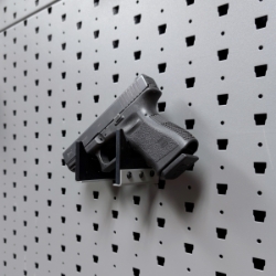 Horizontal pistol hanger mounted on GallowTech wall panel holding a handgun at a right angle