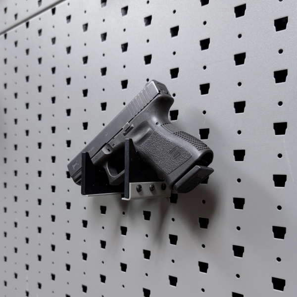 Horizontal pistol hanger mounted on GallowTech wall panel holding a handgun at a right angle