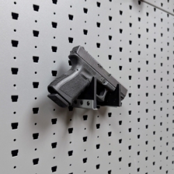 Hybrid Handgun Hanger Right holding a handgun, right-facing mount on Gallow wall panel