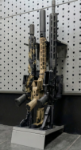 Hybrid vertical stock floor shelf holding three rifles, installed with wall-mounted installation bar