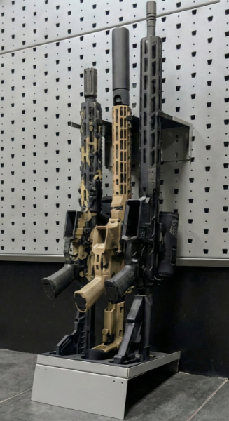 Hybrid vertical stock floor shelf holding three rifles, installed with wall-mounted installation bar