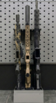 Hybrid vertical stock floor shelf holding three rifles, straight-on front view