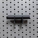 Medium horizontal suppressor hanger holding rifle suppressor, straight-on view