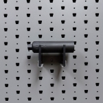 Medium horizontal suppressor hanger holding pistol suppressor straight-on view
